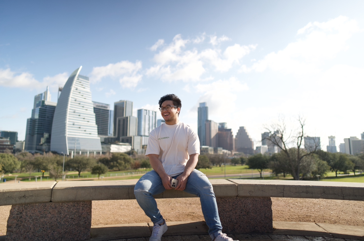 The coach is sitting with beautiful city background.